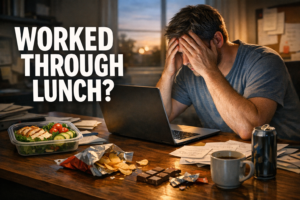 Overworked person at a desk staring at a laptop beside an untouched keto lunch container and evening snack clutter with bold text Worked Through Lunch?