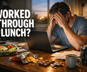 Overworked person at a desk staring at a laptop beside an untouched keto lunch container and evening snack clutter with bold text Worked Through Lunch?